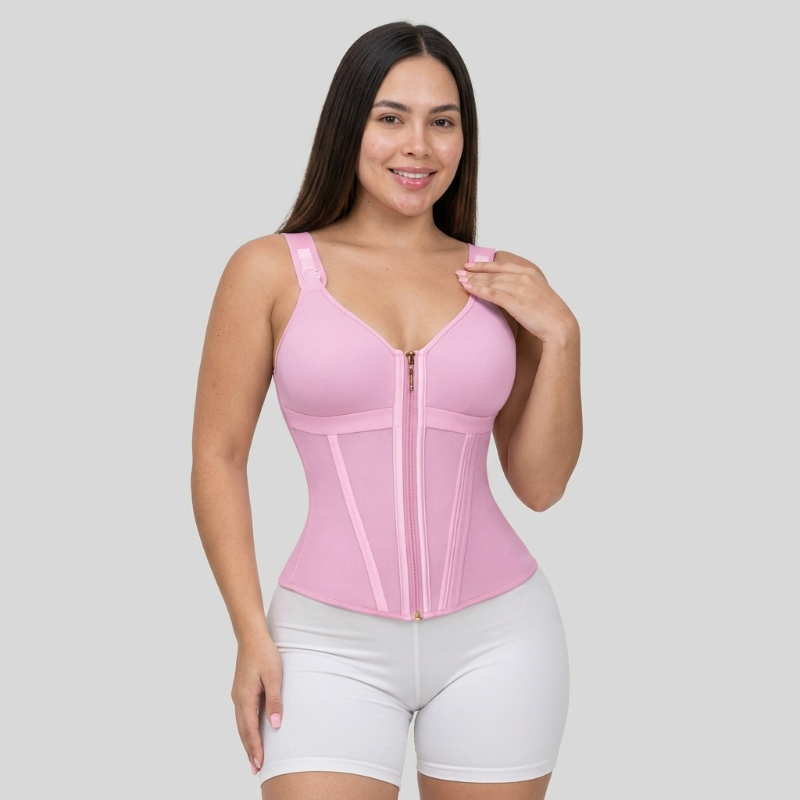 Woman wearing a pink waist trainer on a gray background
